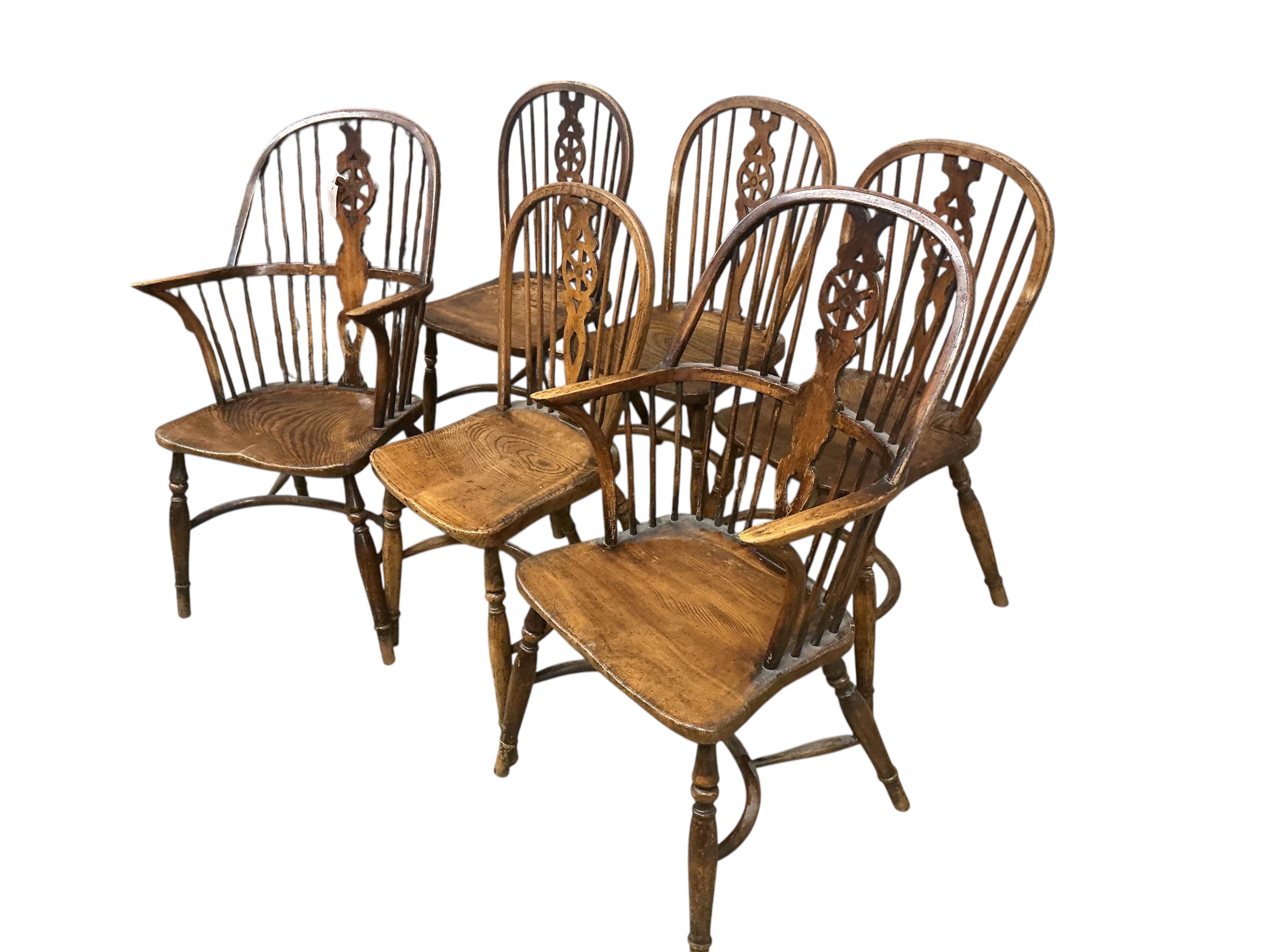 A set of six 20th century elm and beech Windsor chairs with pierced splats and crinoline stretchers, two with arms